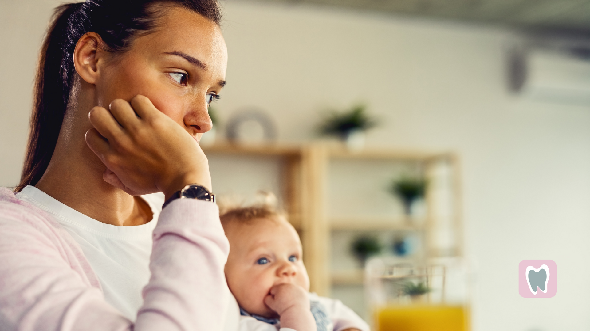 A woman is holding a baby in her arms.