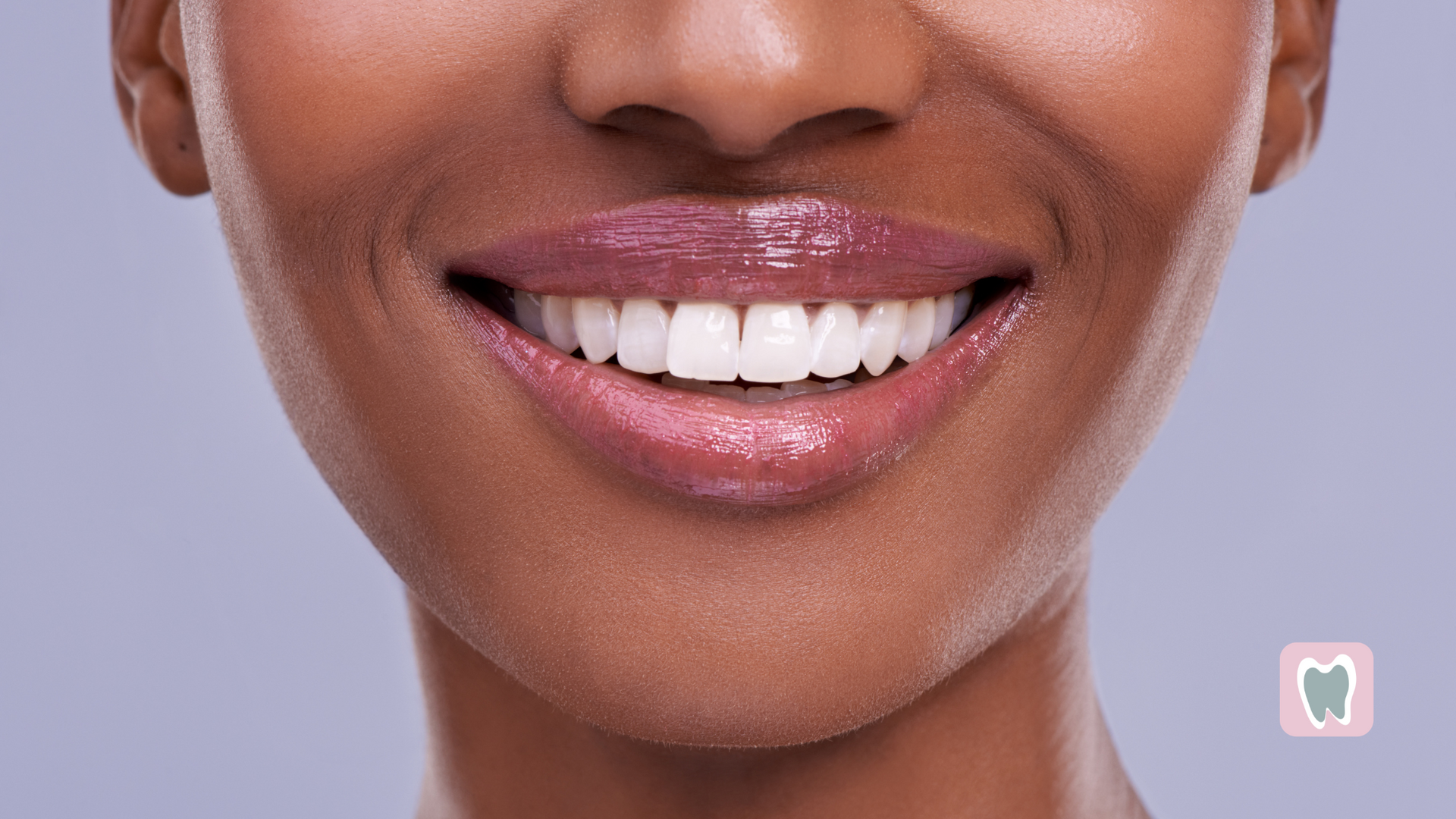 A close up of a woman 's smile with white teeth.