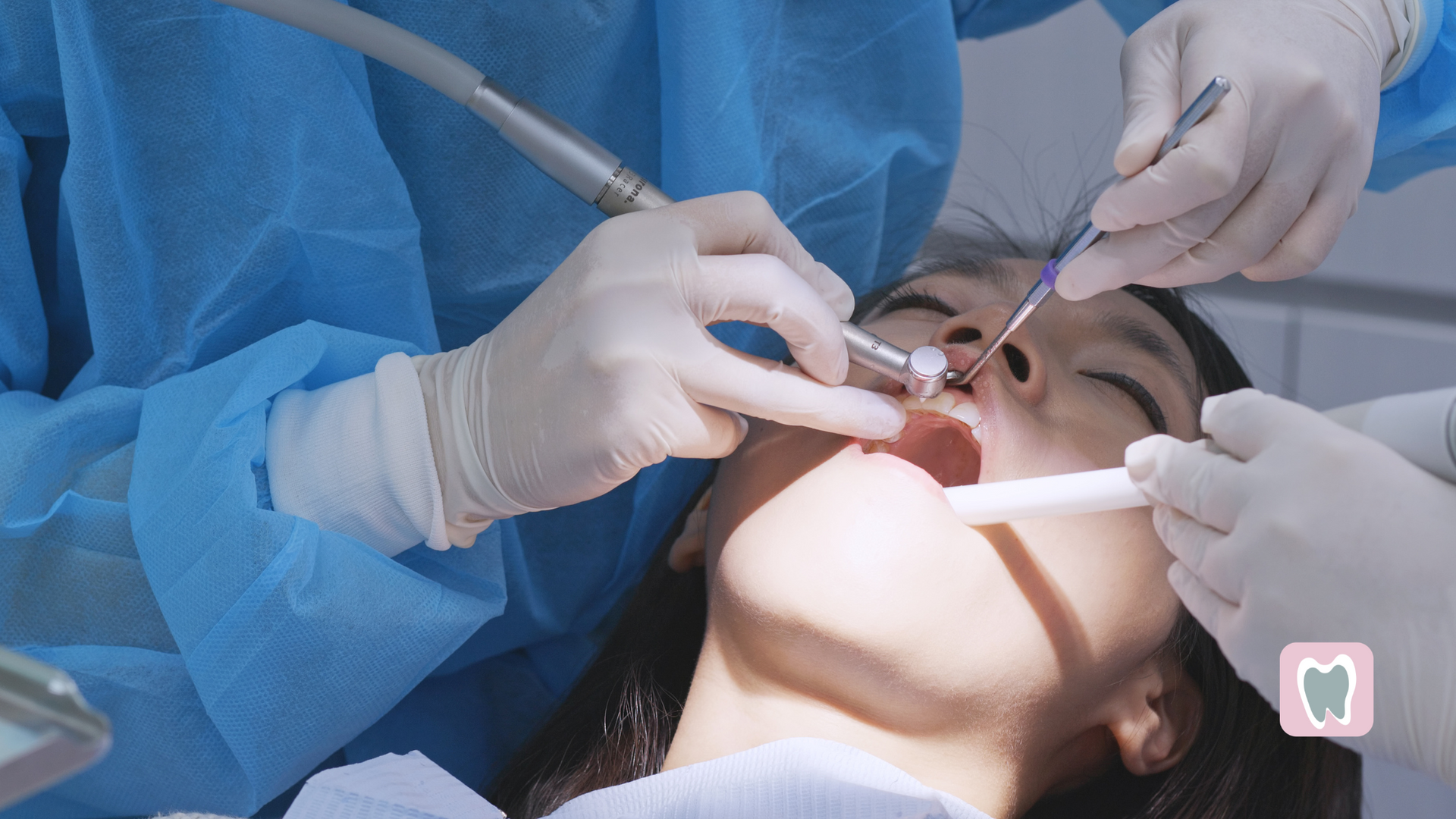 A woman is getting her teeth examined by a dentist.