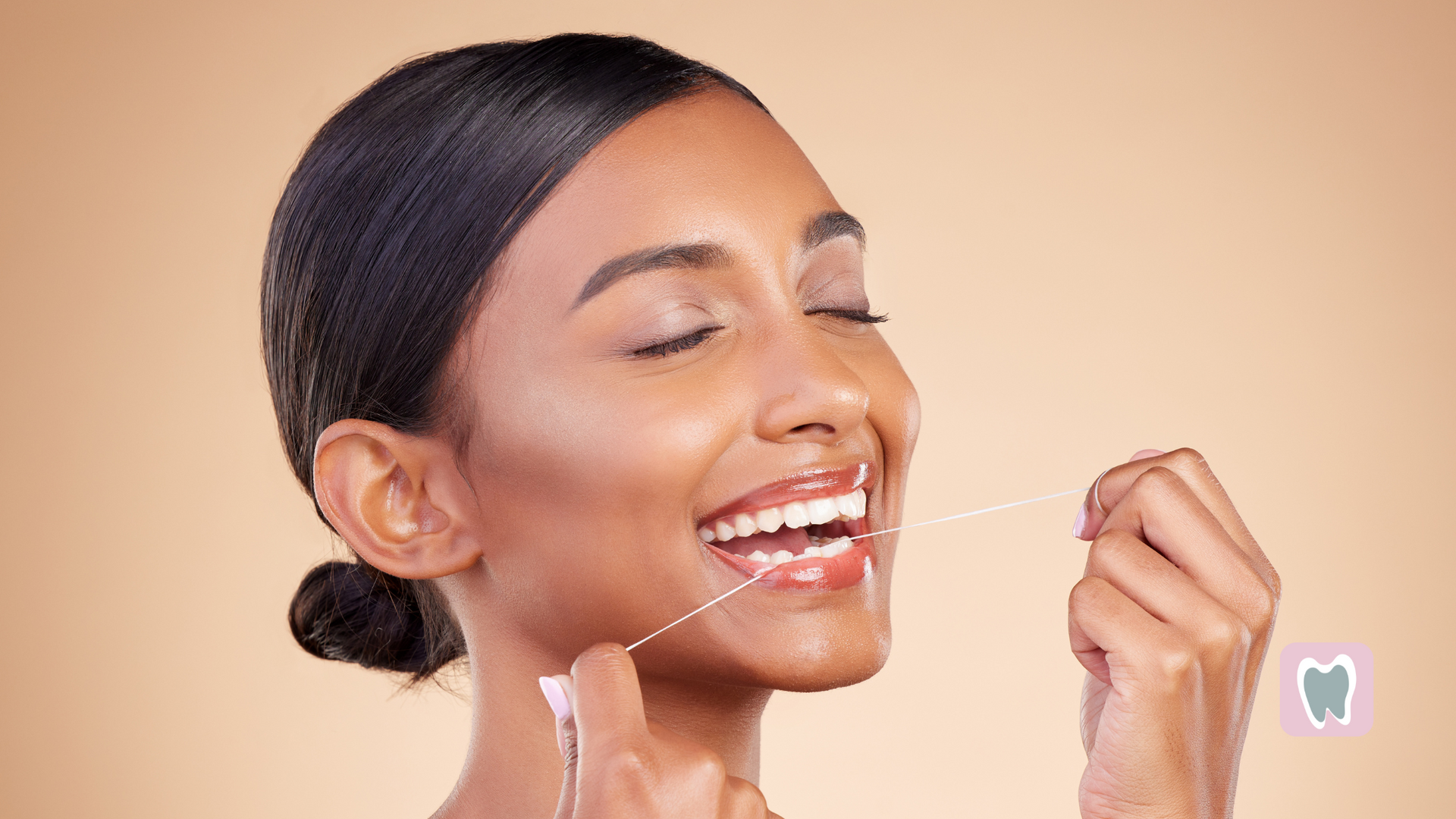 A woman is flossing her teeth with a dental floss.