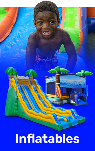 A young boy is playing on an inflatable water slide.