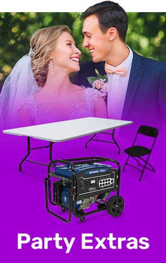 A bride and groom are standing next to a table and chairs.