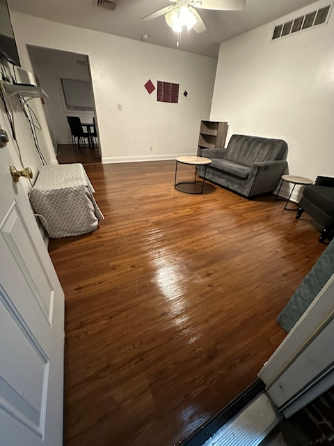A living room with hardwood floors and a couch