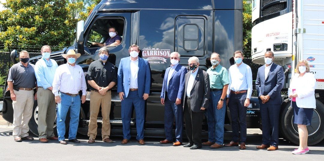 Large Group standing in front of big rig