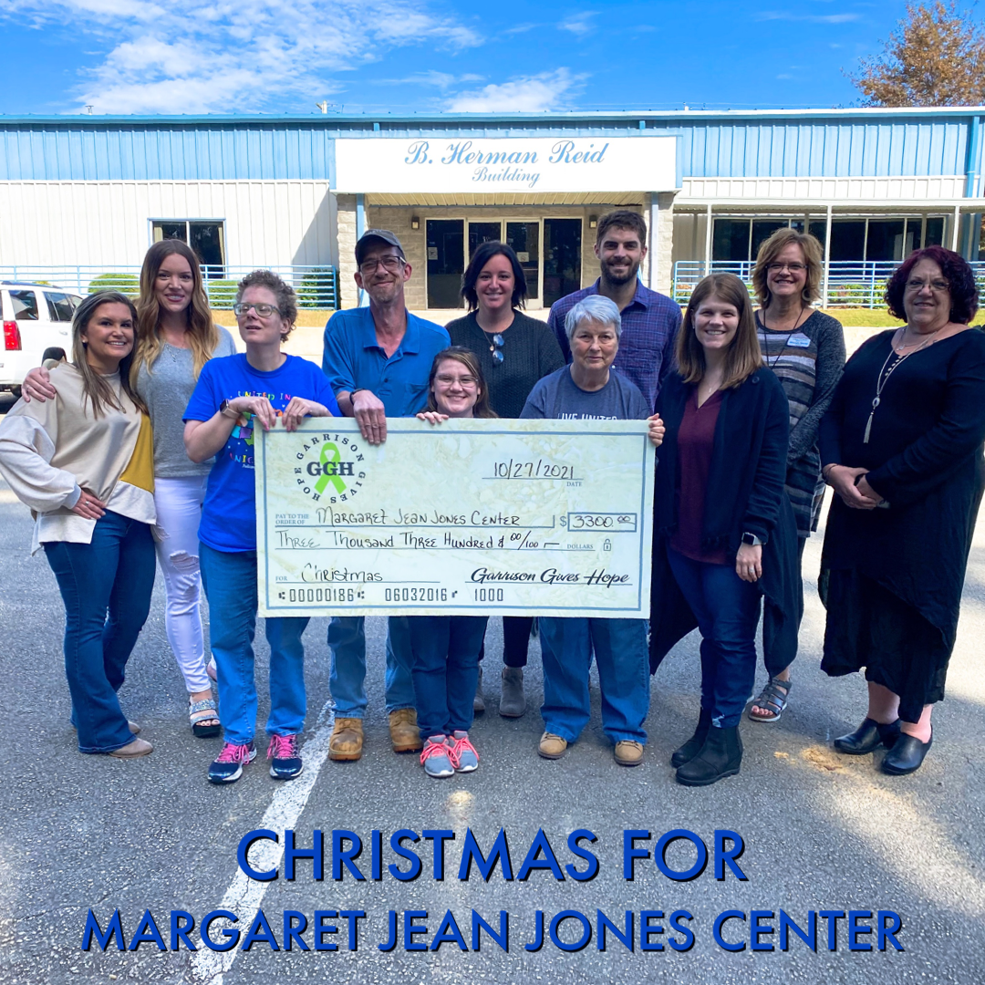 Garrison gifting money for Christmas for Margaret Jean Jones Center