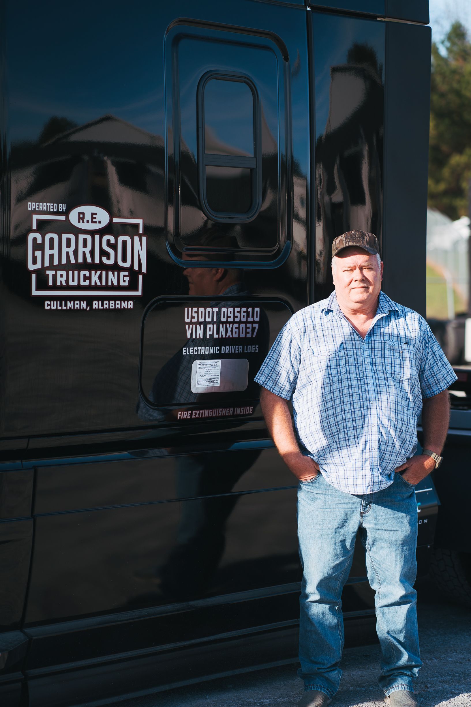 Truck Driver Standing In front of His 18-Wheeler