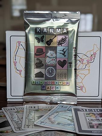 A photo of a Karma card game booster pack, in printed foil packaging, for the Eras Tour shows in Seattle.