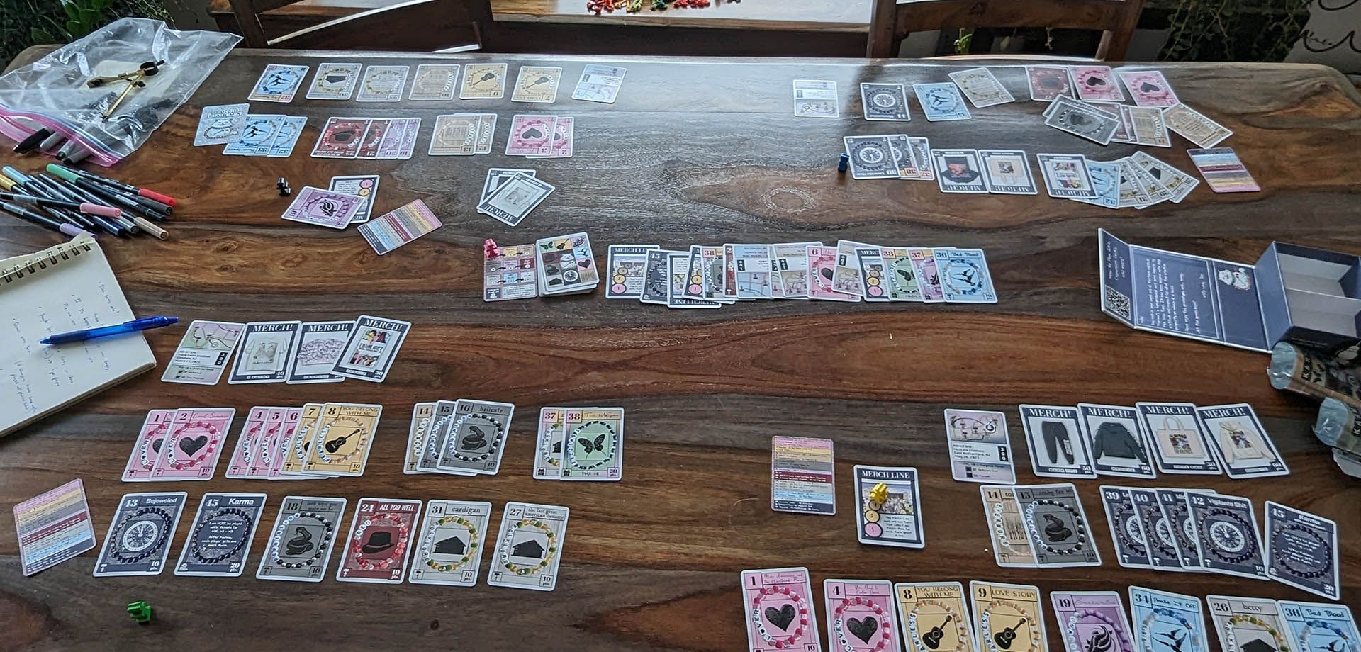 A picture of the colorful printed game cards with Taylor Swift's eras, songs, and merch on them.