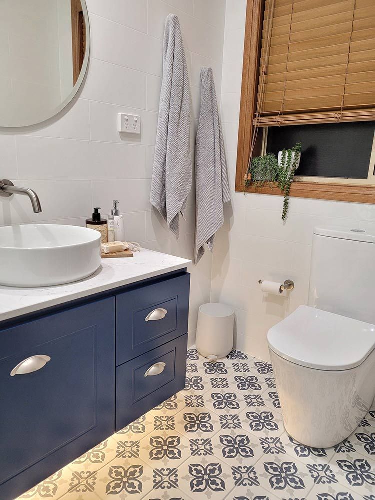 A Bathroom With A Sink, Toilet And Mirror — Chandolin Construction In Robin Hill, NSW