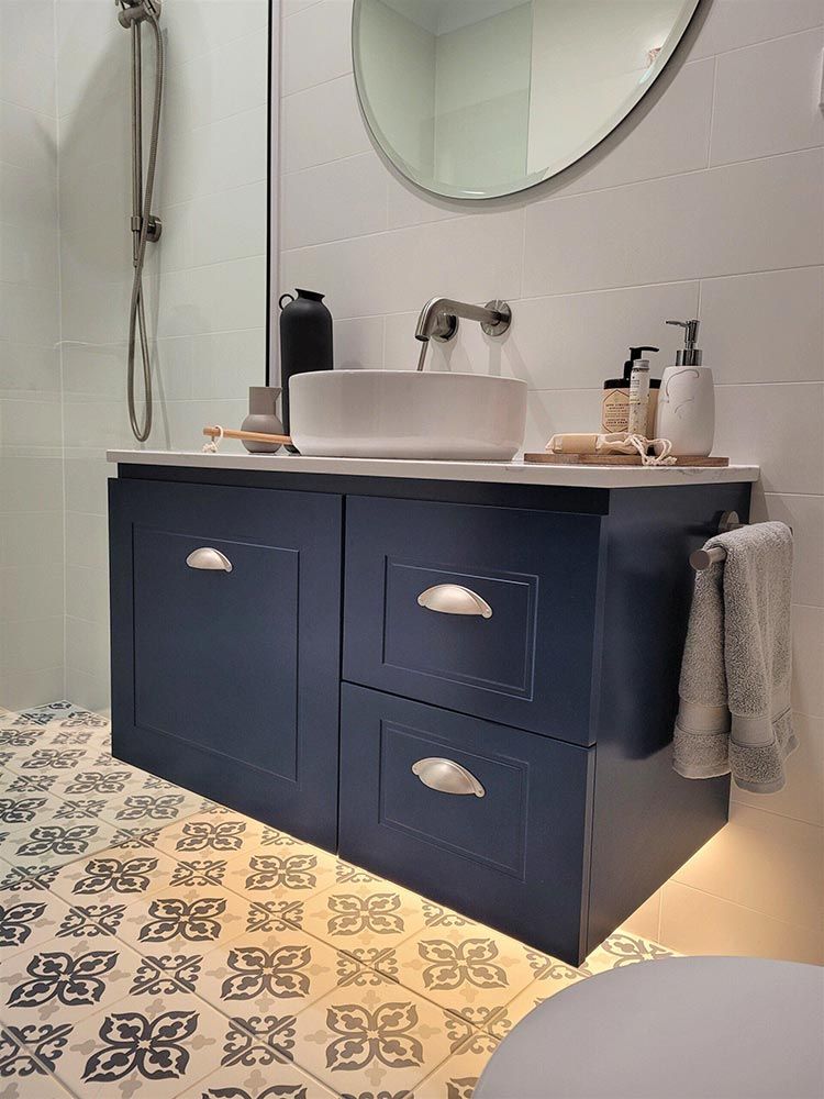 A Bathroom With A Sink, Mirror And Toilet — Chandolin Construction In Robin Hill, NSW