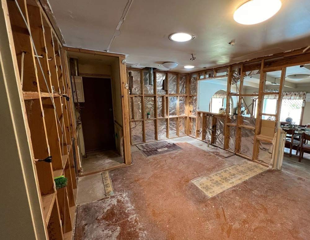 A Room With A Lot Of Wooden Shelves And A Ceiling Light — Chandolin Construction In Robin Hill, NSW