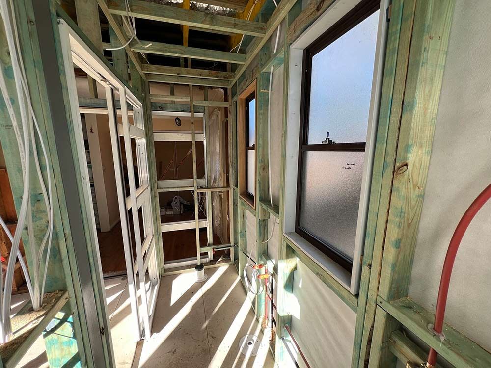 A Hallway In A House Under Construction With A Lot Of Windows — Chandolin Construction In Robin Hill, NSW