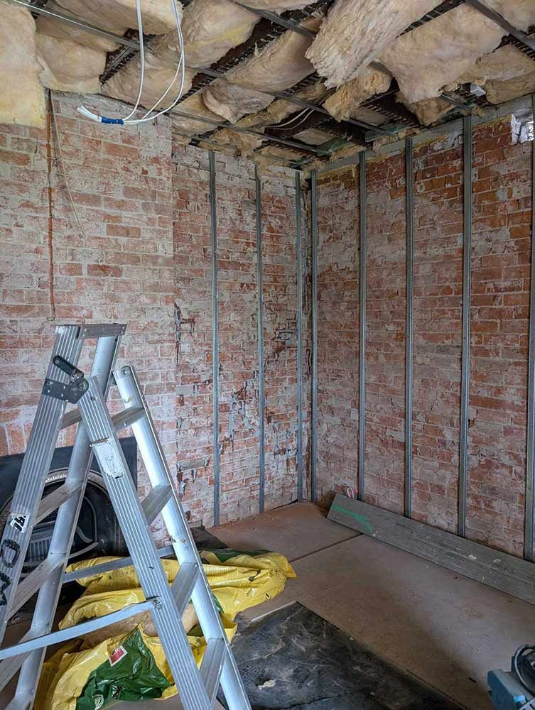 A Room With A Ladder In It And A Brick Wall — Chandolin Construction In Robin Hill, NSW