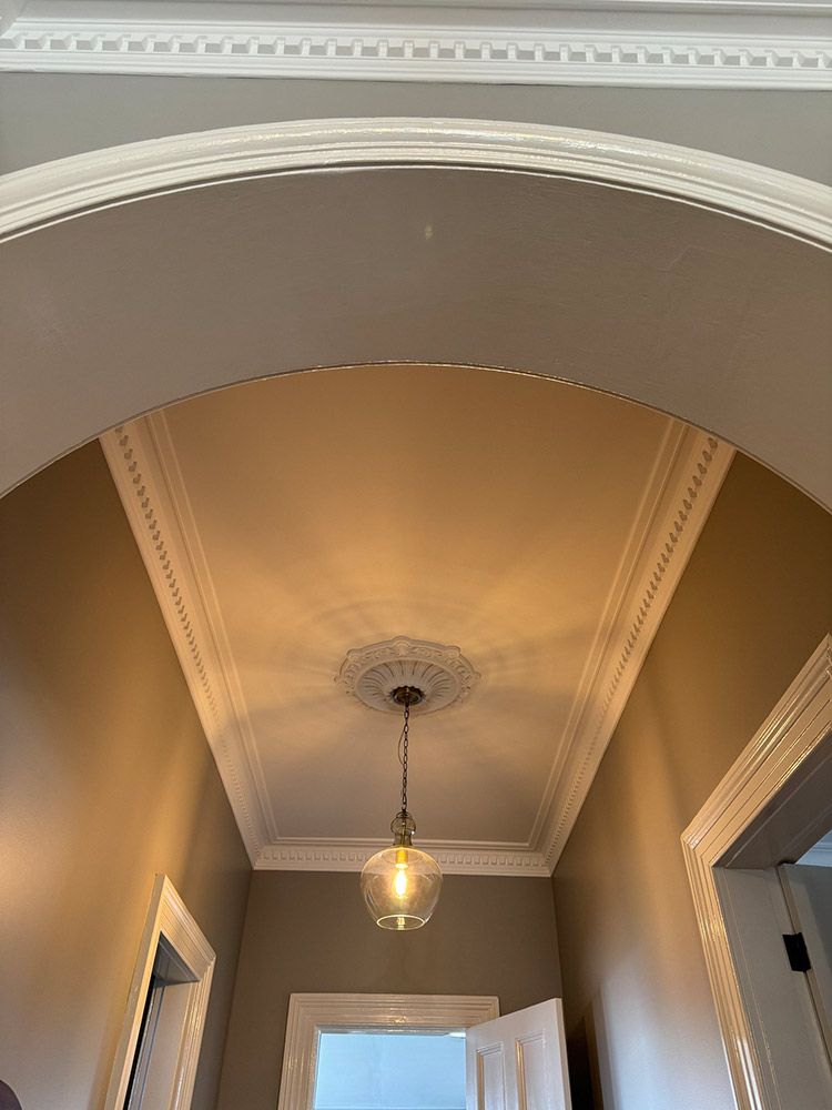 A Hallway With A Ceiling Light Hanging From It — Chandolin Construction In Robin Hill, NSW