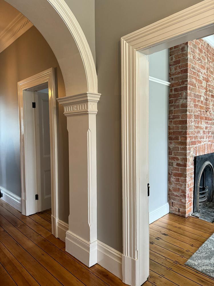 There Is A Brick Fireplace In The Middle Of The Room — Chandolin Construction In Robin Hill, NSW