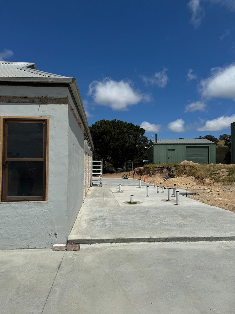 Two Men Are Working On A Wooden Structure In A Yard — Chandolin Construction In Robin Hill, NSW