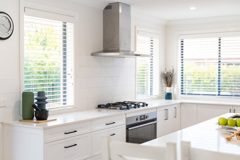 A Kitchen With White Cabinets — Chandolin Construction In Robin Hill, NSW