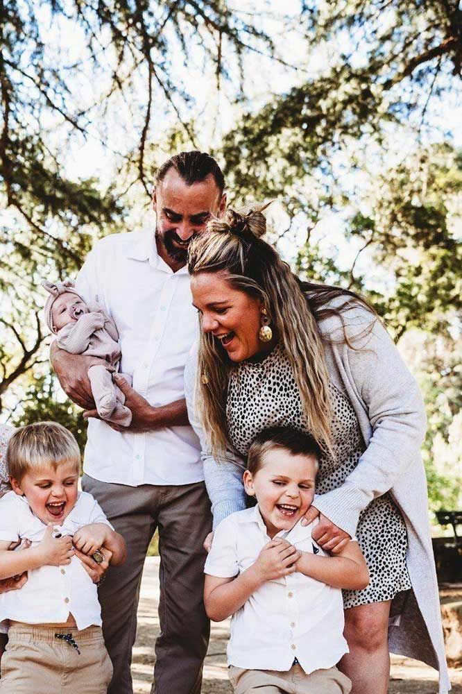 A Family Is Posing For A Picture In A Park — Chandolin Construction In Robin Hill, NSW