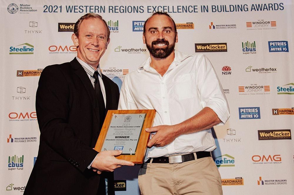 Two Men Are Holding A Plaque — Chandolin Construction In Robin Hill, NSW