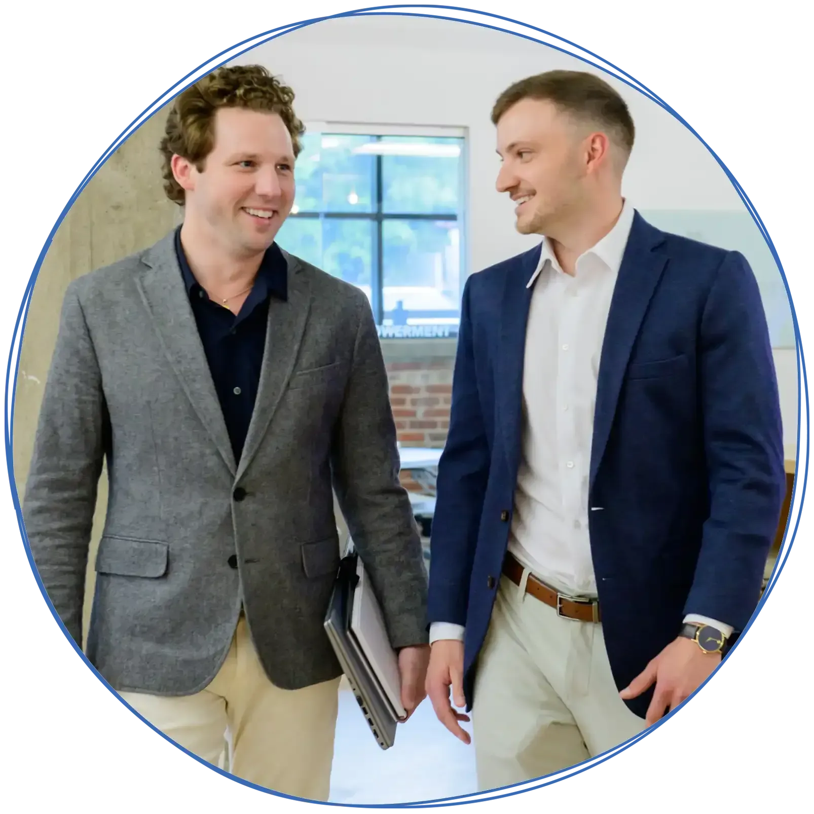 People in a business meeting around a table, using laptops and discussing ideas. Blue and white colors.