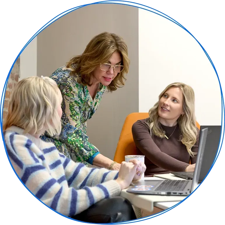 People in a business meeting around a table, using laptops and discussing ideas. Blue and white colors.