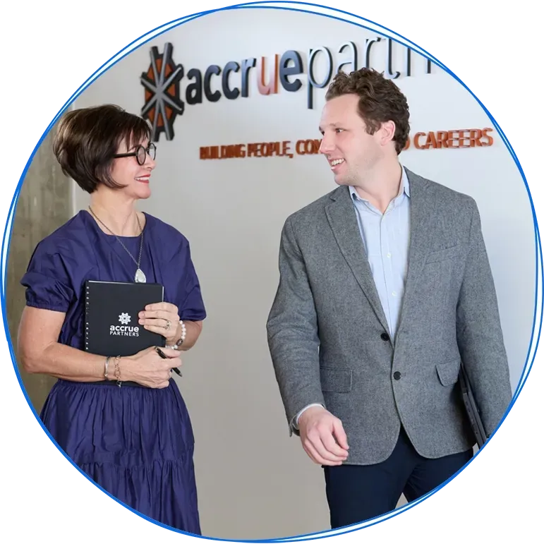 People in a business meeting around a table, using laptops and discussing ideas. Blue and white colors.
