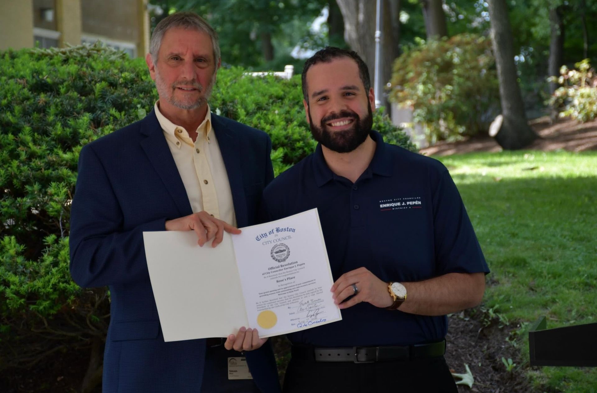 Steve Winn BHN President & CEO is standing with Boston City Councilor Enrique J. Pepén holding a citation formally recognizing the grand opening of Rose's House.