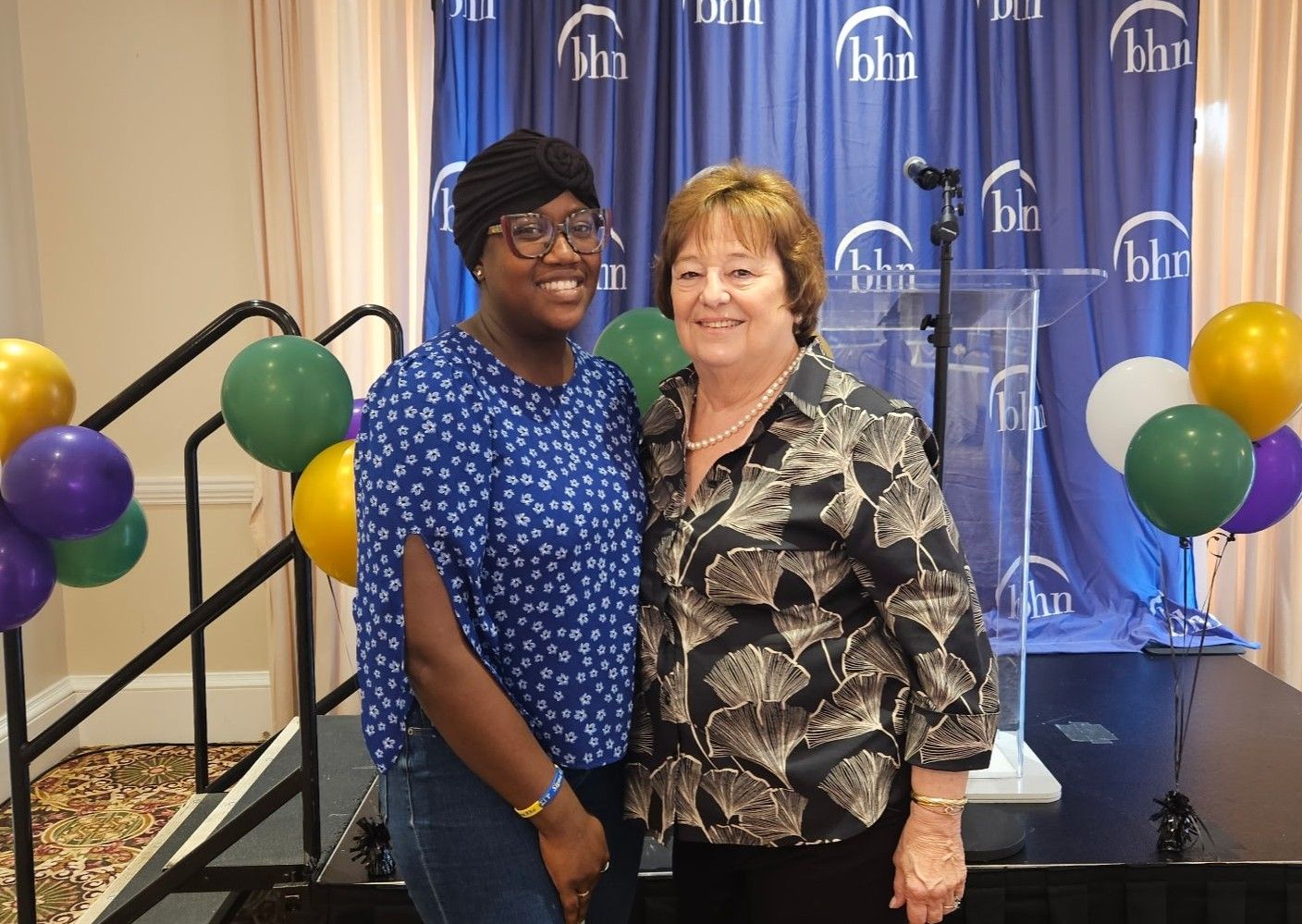 Kathy Wilson stands with a staff excellence fund recipient at the celebration.