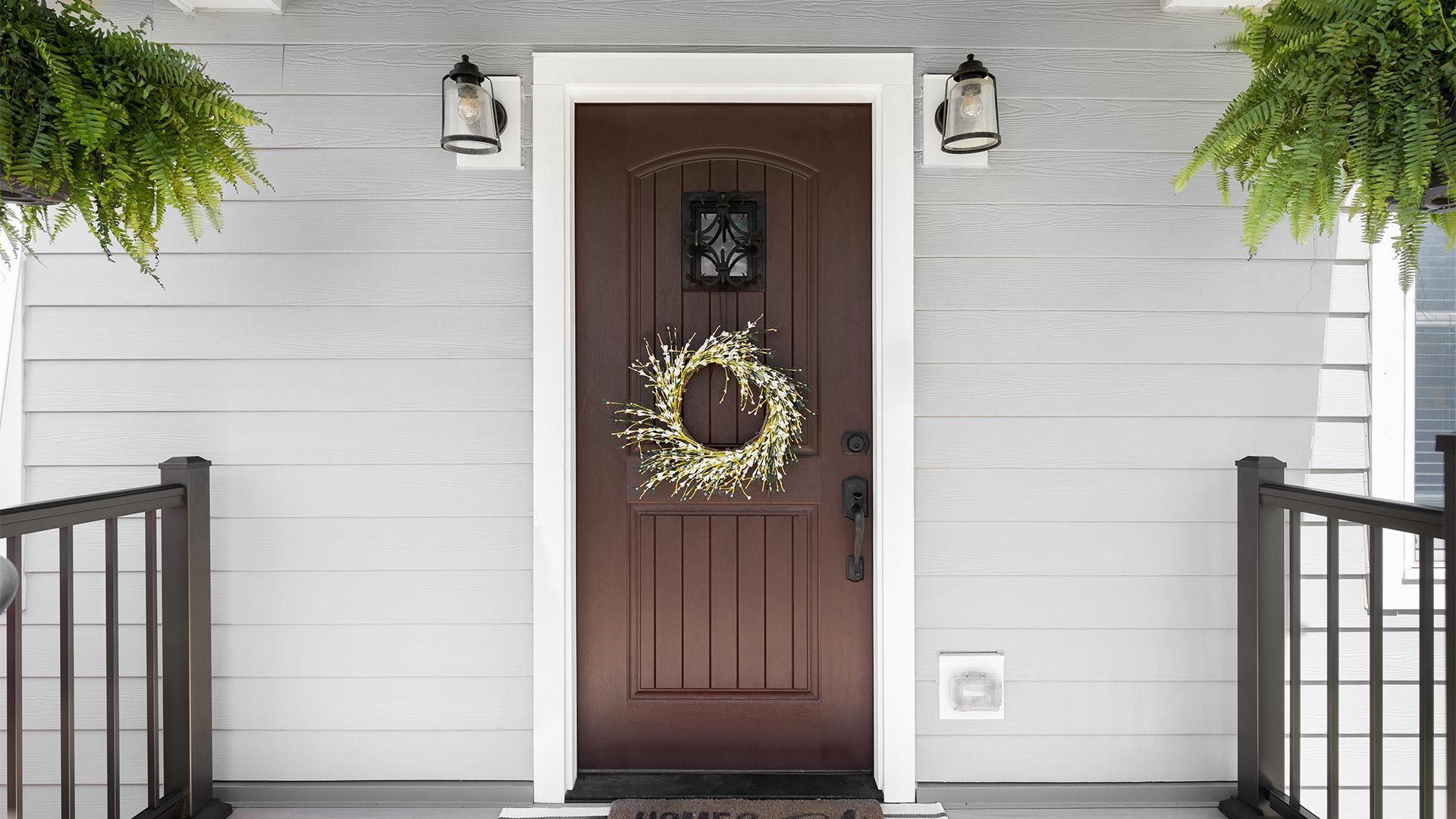 The front door of a house with a wreath on it.