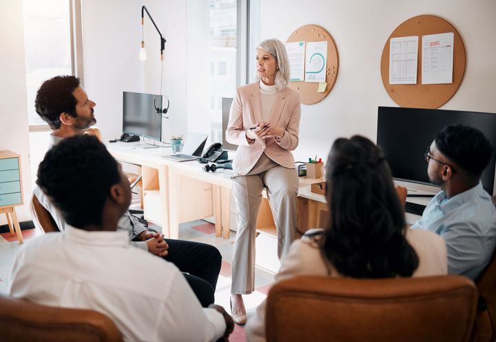 A woman is giving a presentation to a group of people.