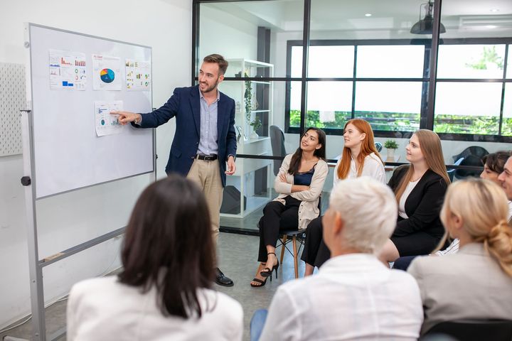 A man is giving a presentation to a group of people.