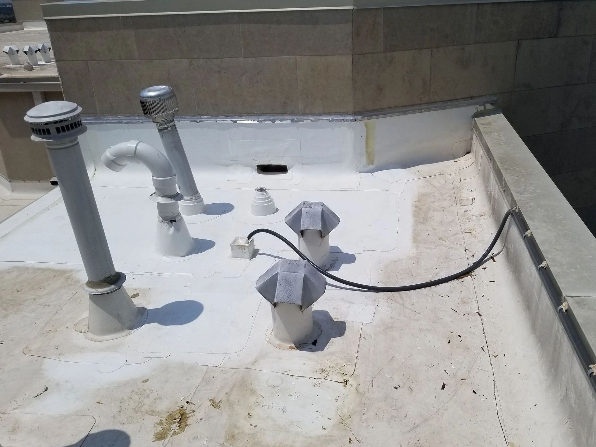 A white roof with a bunch of pipes on it