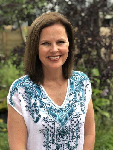 Elaine Lambert standing near a tree