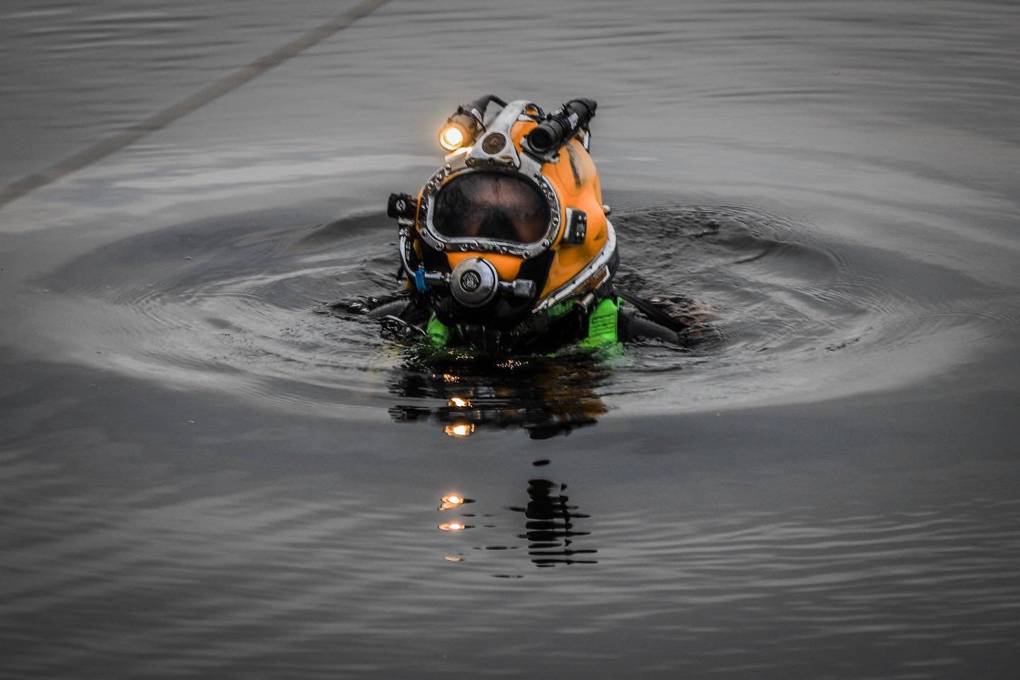 diver half way under water