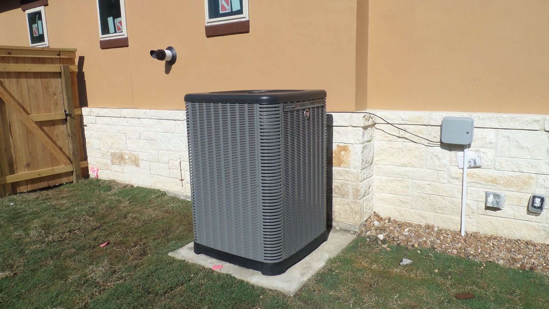 An air conditioner is sitting on the side of a house
