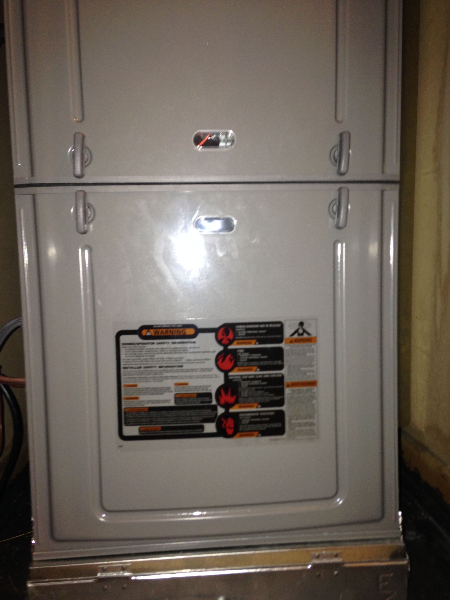 A white refrigerator with a warning label on it