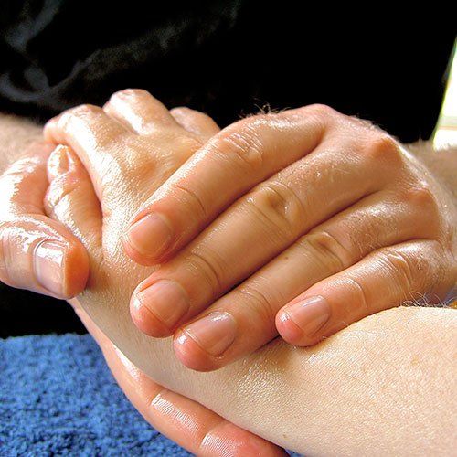A close up of a person holding another person 's hand