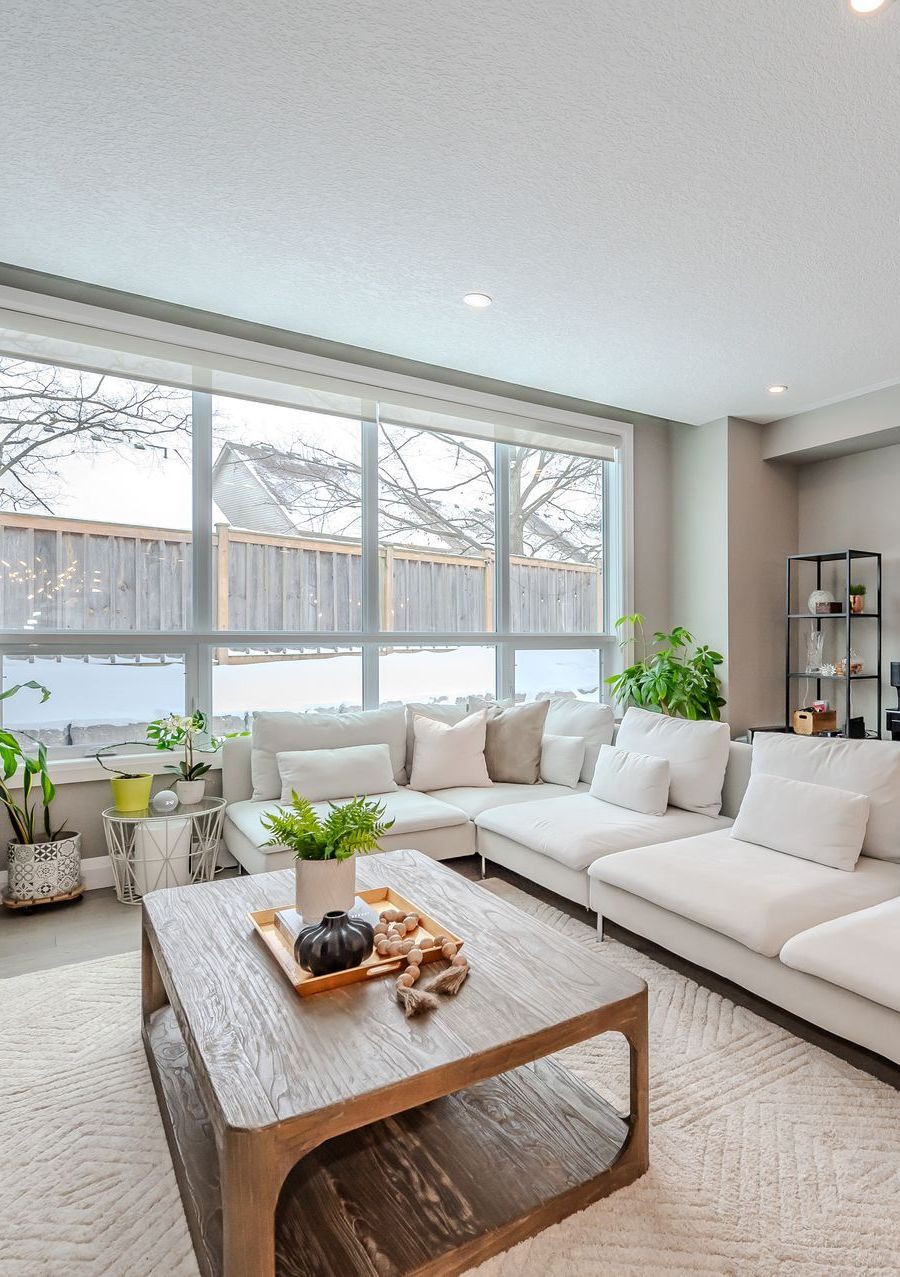 A living room with a fireplace , coffee table , and mirror.