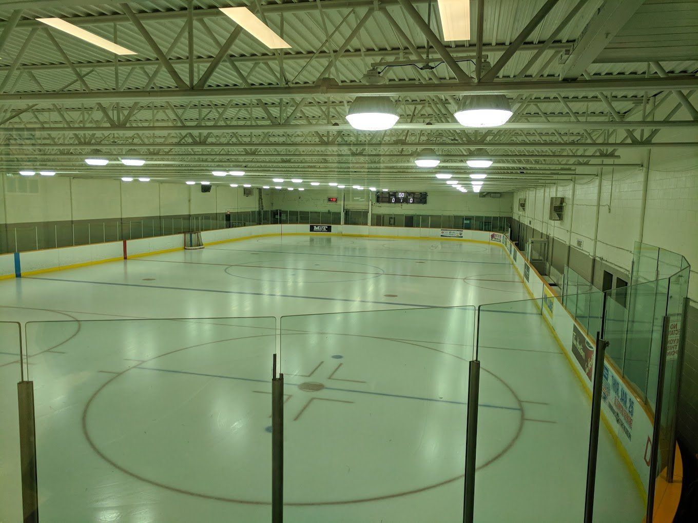 A large indoor ice rink with a circle in the middle