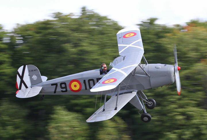 A small propeller plane is flying through the air.