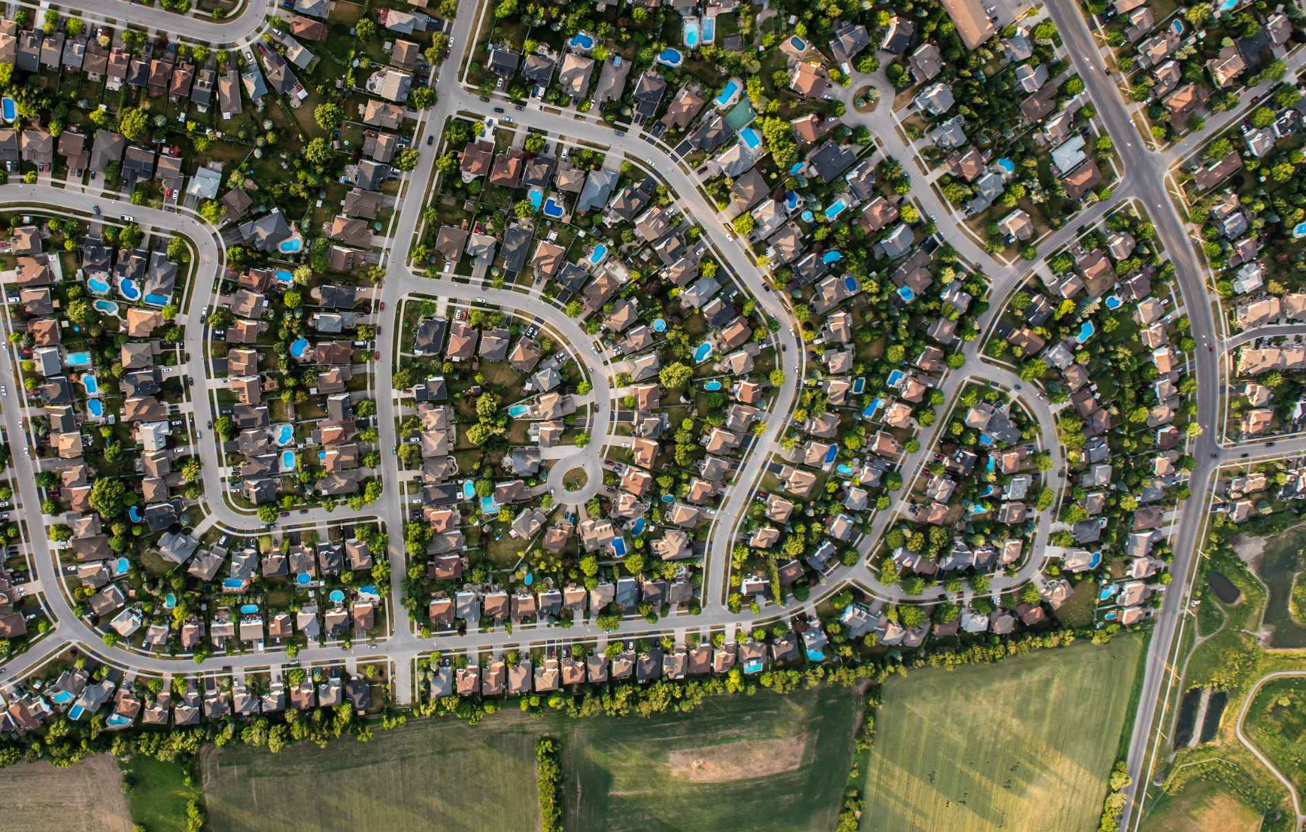 An aerial view of a residential area with lots of houses and trees.