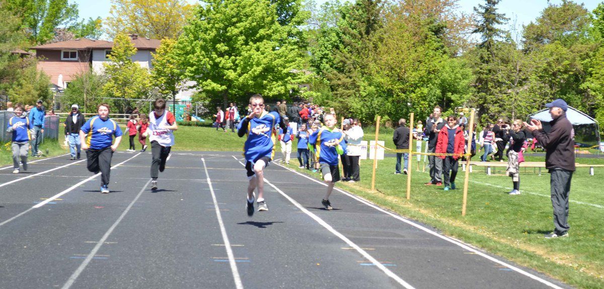 A group of people are running on a track.