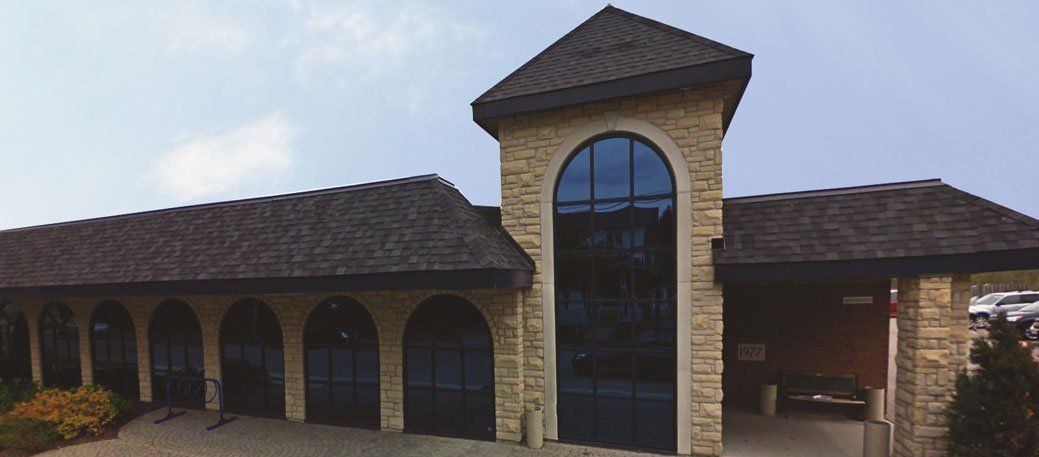 A large stone building with a roof and arched windows