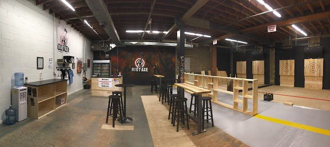 A large room with tables and stools in it.