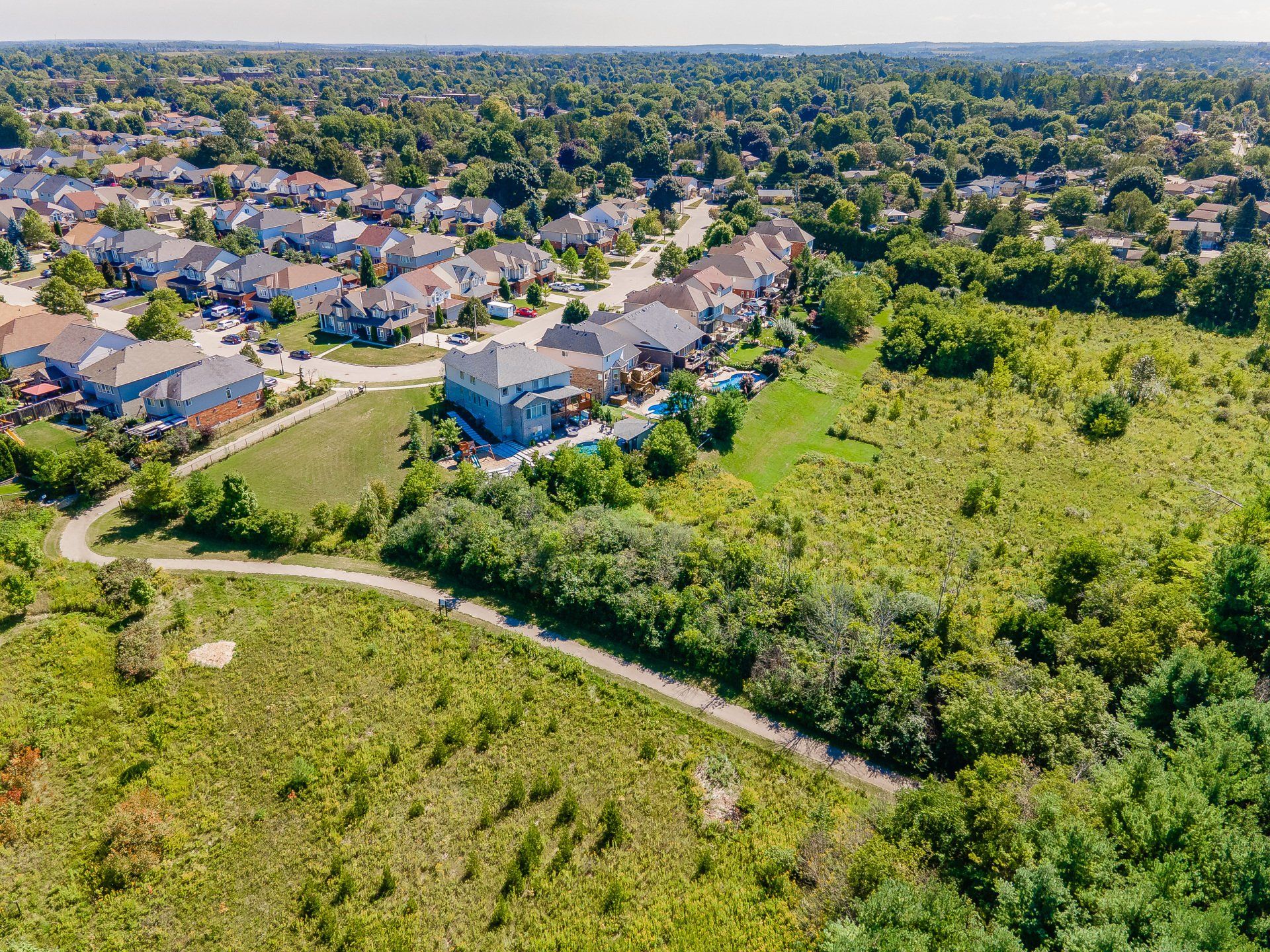 An aerial view of a residential area with lots of trees and houses.