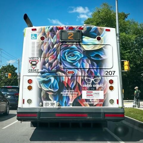 The back of a bus has a picture of a woman on it