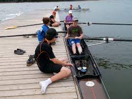 A group of people are rowing boats on a lake.