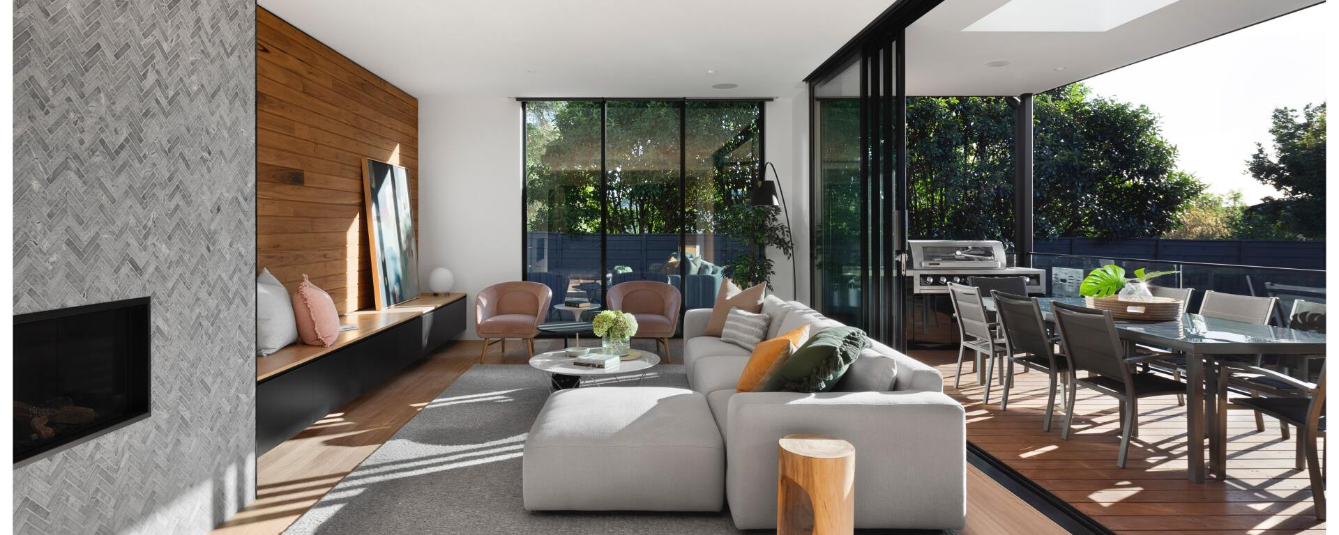 A living room with a couch , chairs , table and fireplace.