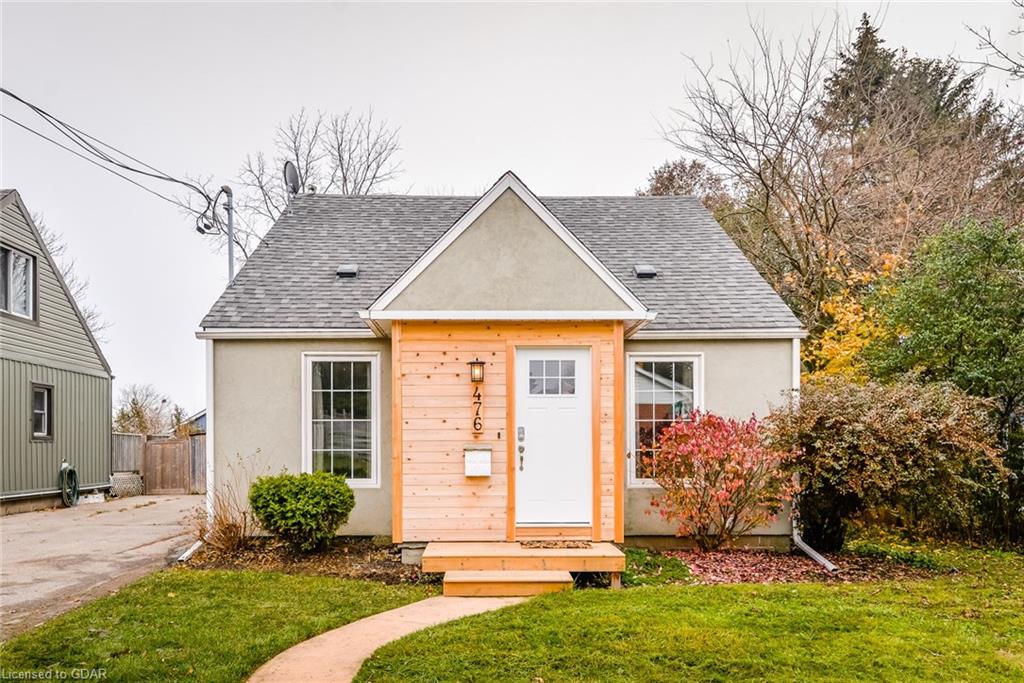 A small house with a wooden porch and a walkway leading to it.