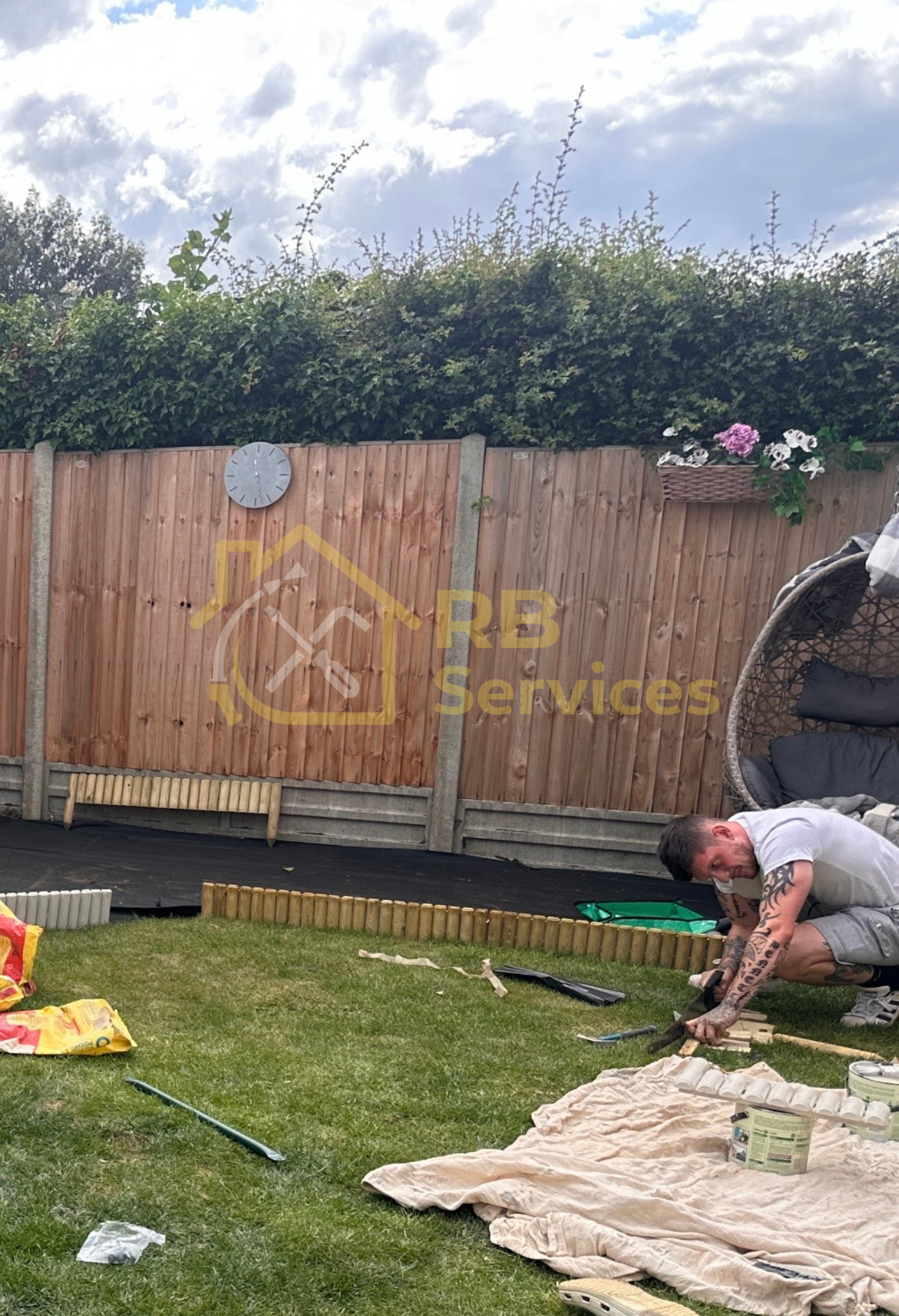 Wooden border fitted and painted for a  children's play area in the garden